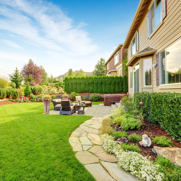 Tree And Shrub Insect Control And Fertilization Services You Can Trust In Ogden, Utah Lush backyard with green lawn, healthy trees, and shrubs in Utah